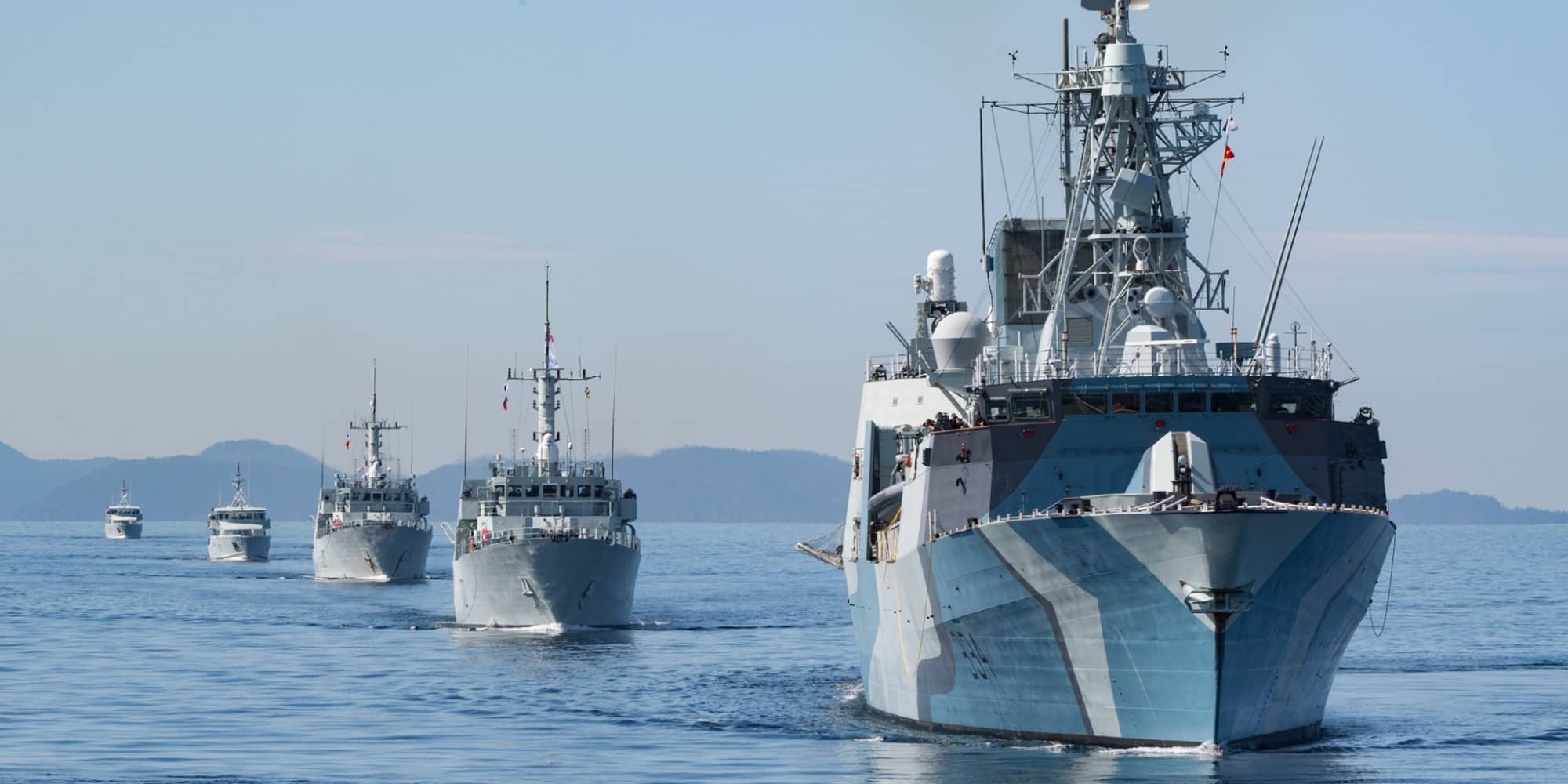 HMCS Regina leads a column of vessels past Cordova Bay in mid-April. CFB Esquimalt is in the midst of a massive deployment with the sole purpose of keeping sailors quarantine at sea (Photo by Royal Canadian Navy).