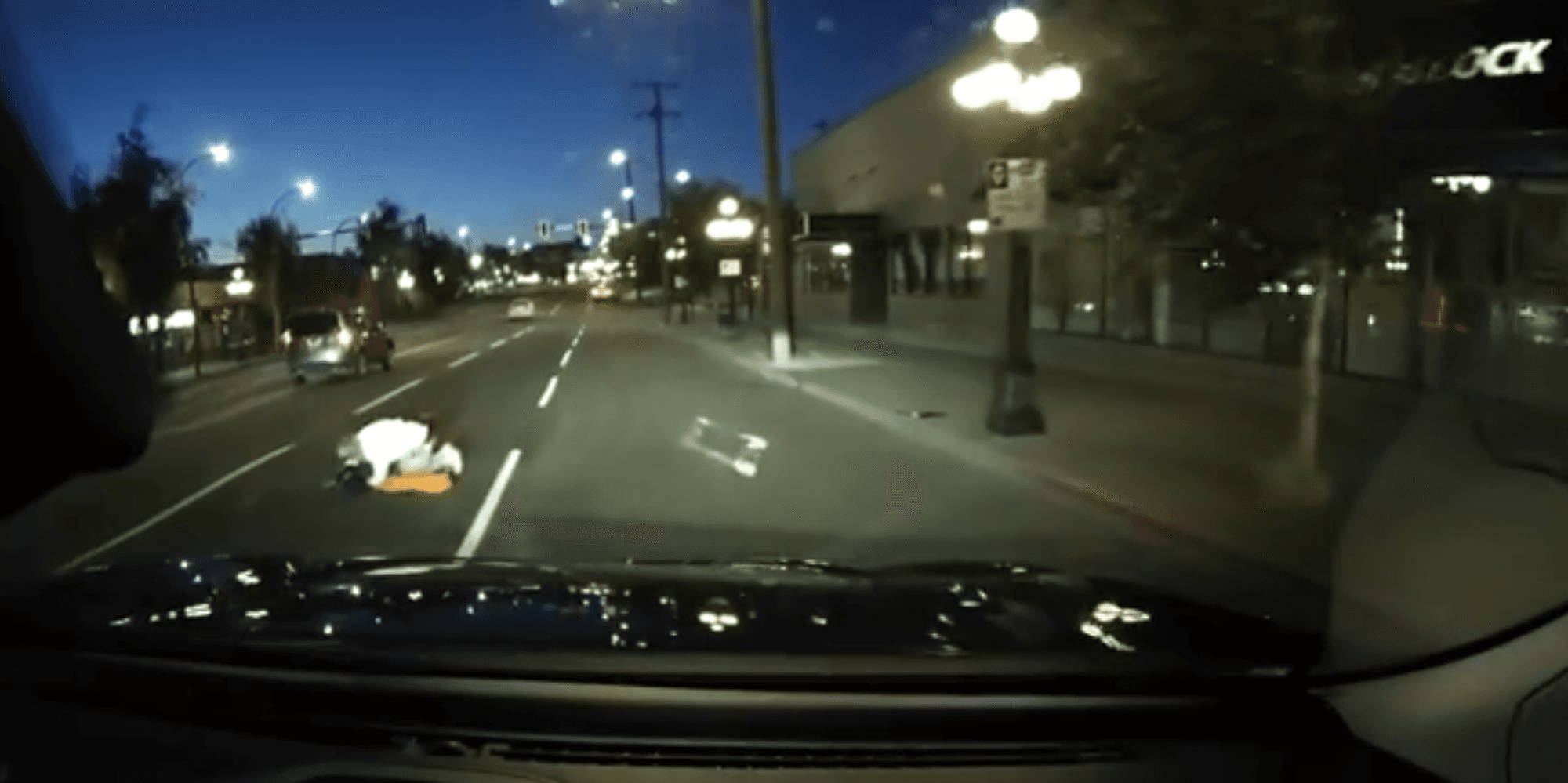 A man lies bleeding in the middle of Douglas Street after being stabbed multiple times in Centennial Square. Dashcam footage captured by Daniel Toye.