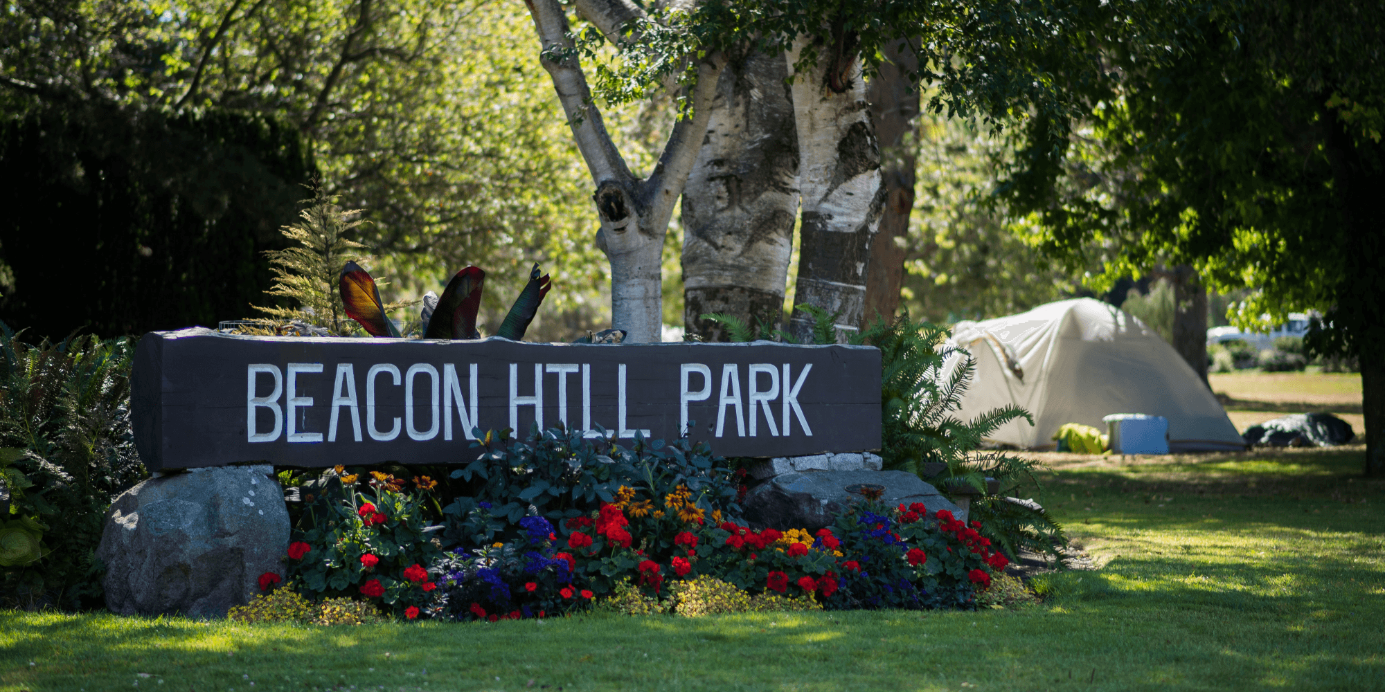 A tent pitched close to the official Beacon Hill Park sign (James MacDonald for The Capital).