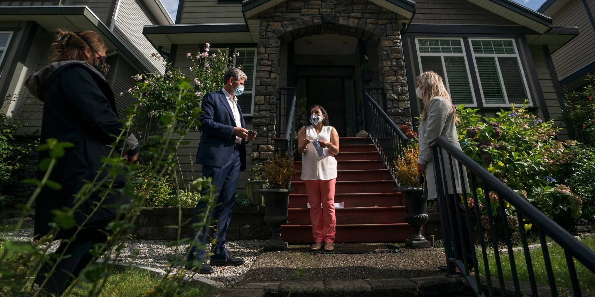 An image taken from the Twitter account of BC Liberal leader Andrew Wilkinson showing a masked, distanced doorstep meeting with a potential voter in Maple Ridge (Twitter.com/Wilkinson4BC).