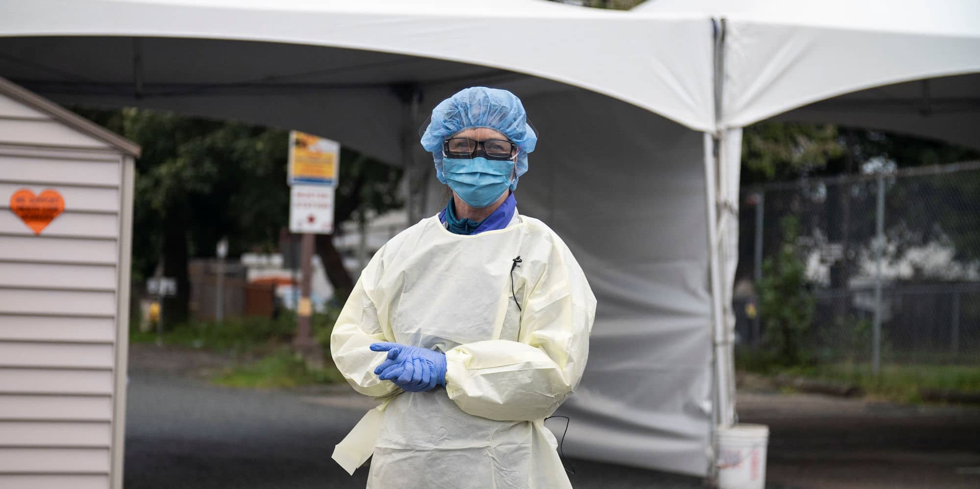 An Island Health employee in full PPE poses at a drive-through COVID-19 testing facility established in June.