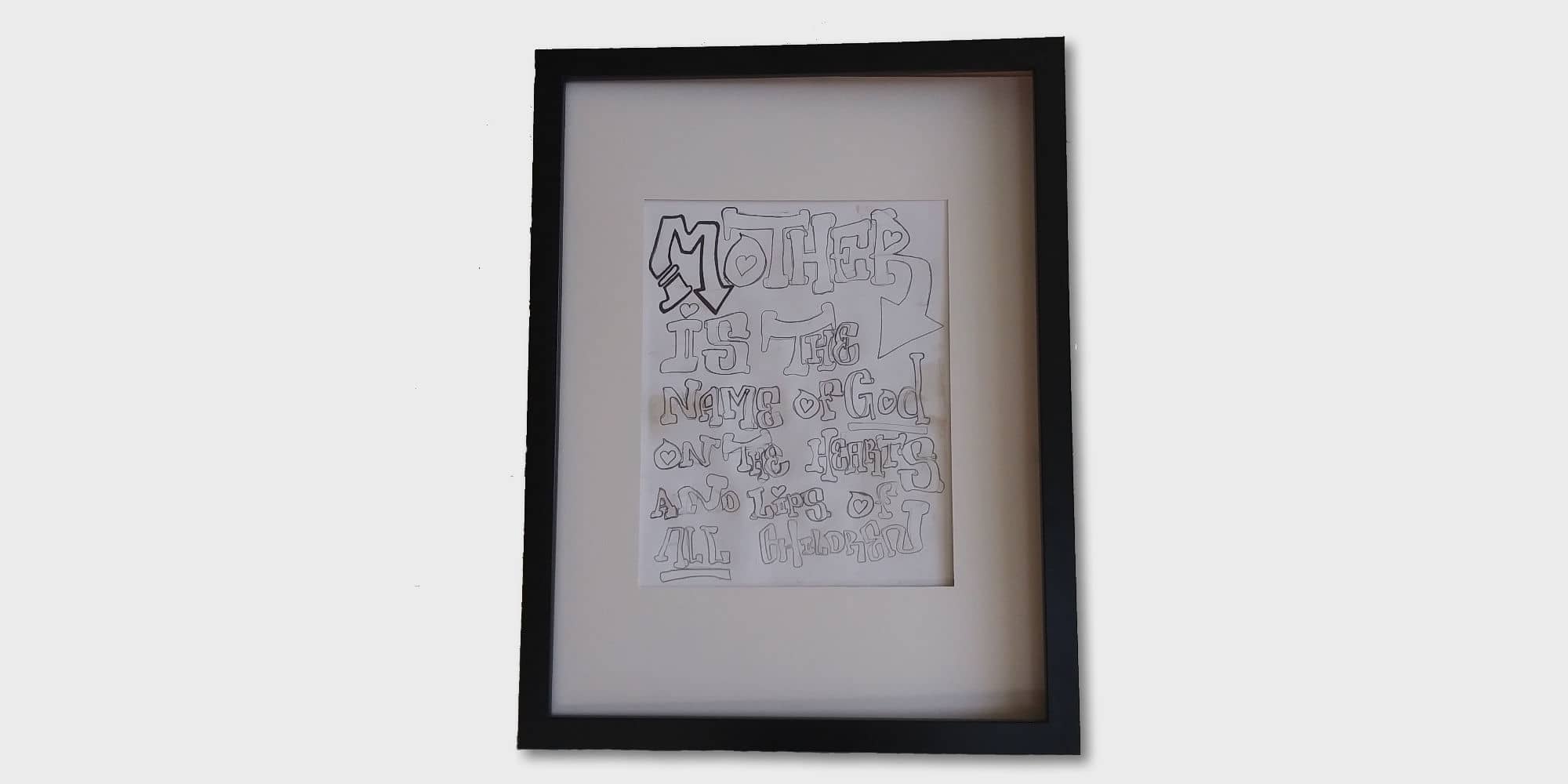 A framed piece of art made by B, one of the homeless men mentioned below, and displayed by his mother Nancy.