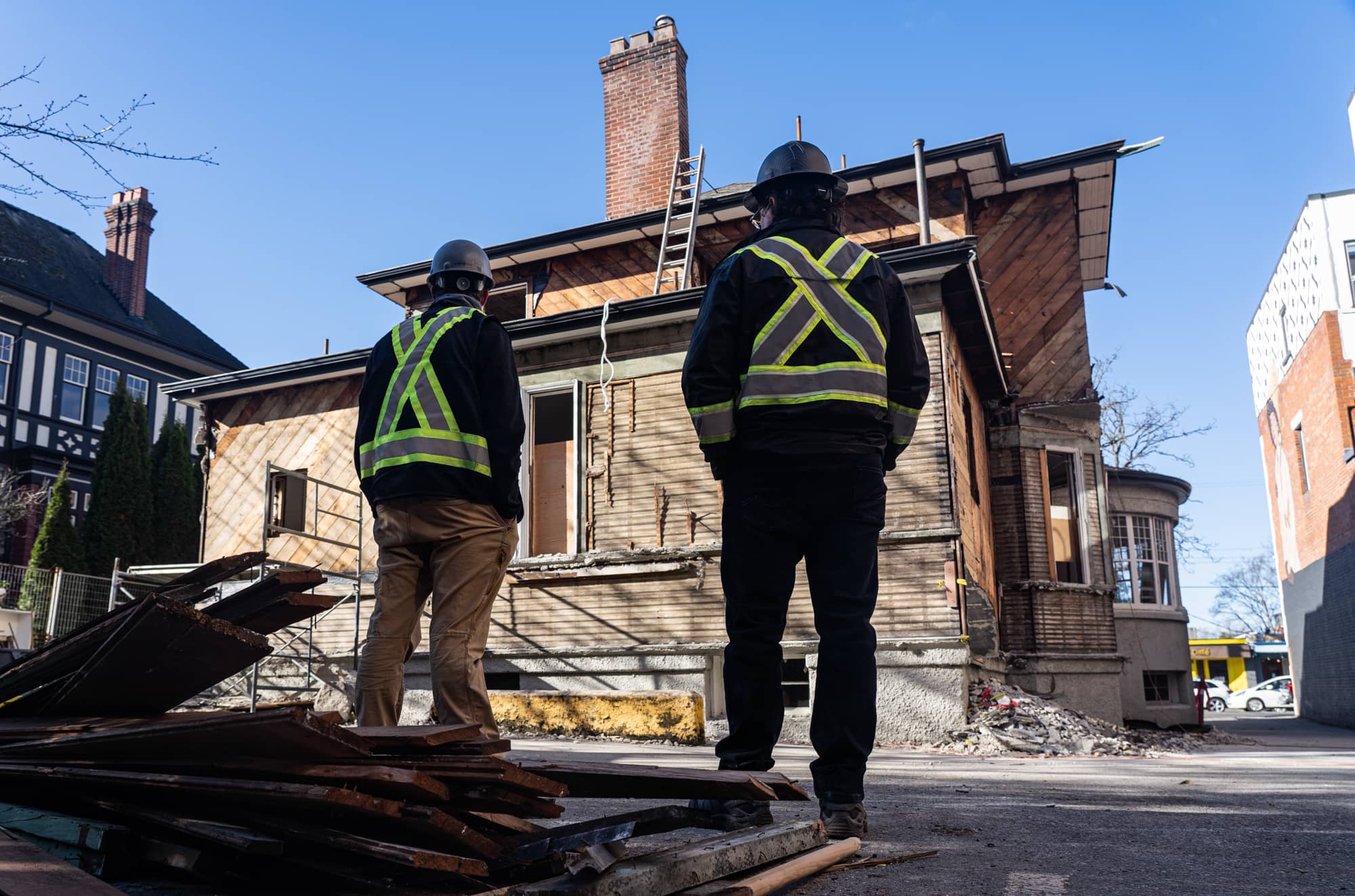 Workers at the Cook Street deconstruction site survey the home. Photo: Jimmy Thomson / Capital Daily