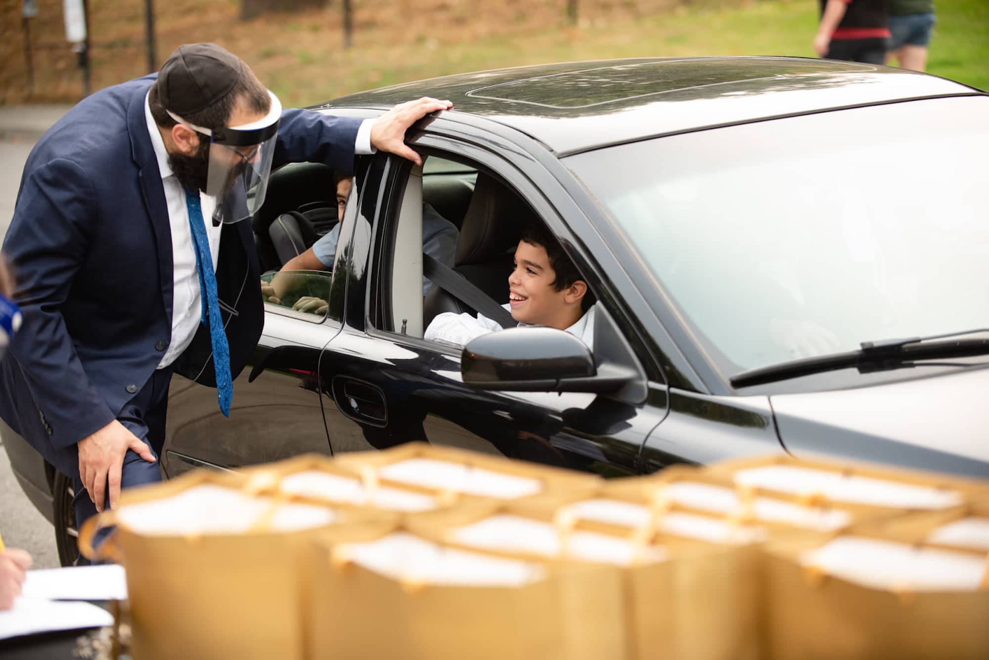 Rabbi Meir Kaplan (left), director of Chabad of Vancouver Island, hands prepared take-home boxes to synagogue members to celebrate Rosh Hashana, the Jewish New Year, which takes place in September.