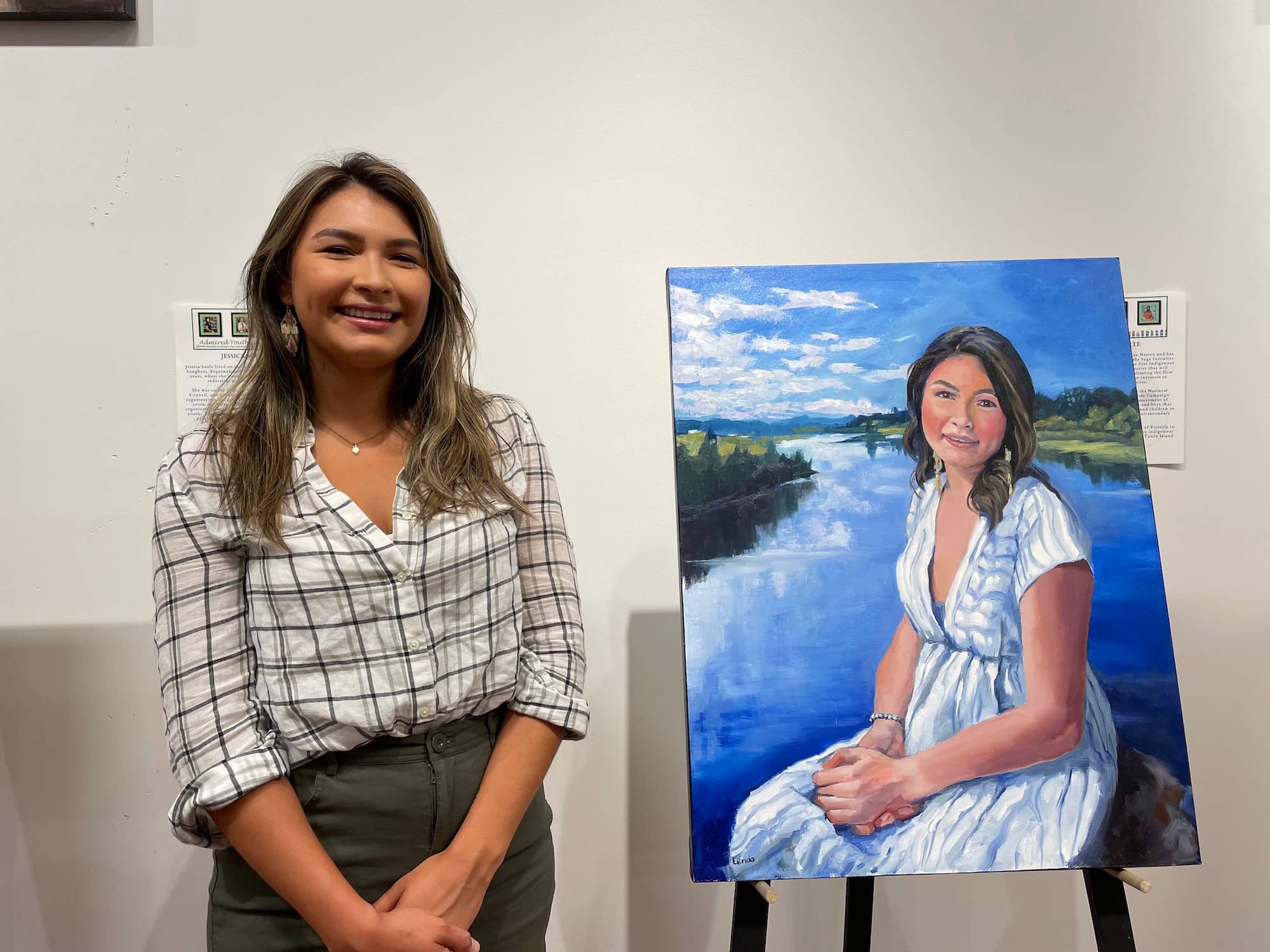 Sage Lacerte, founder of the Sage Initiative, poses with her portrait. Photo: Emily Fagan / Capital Daily