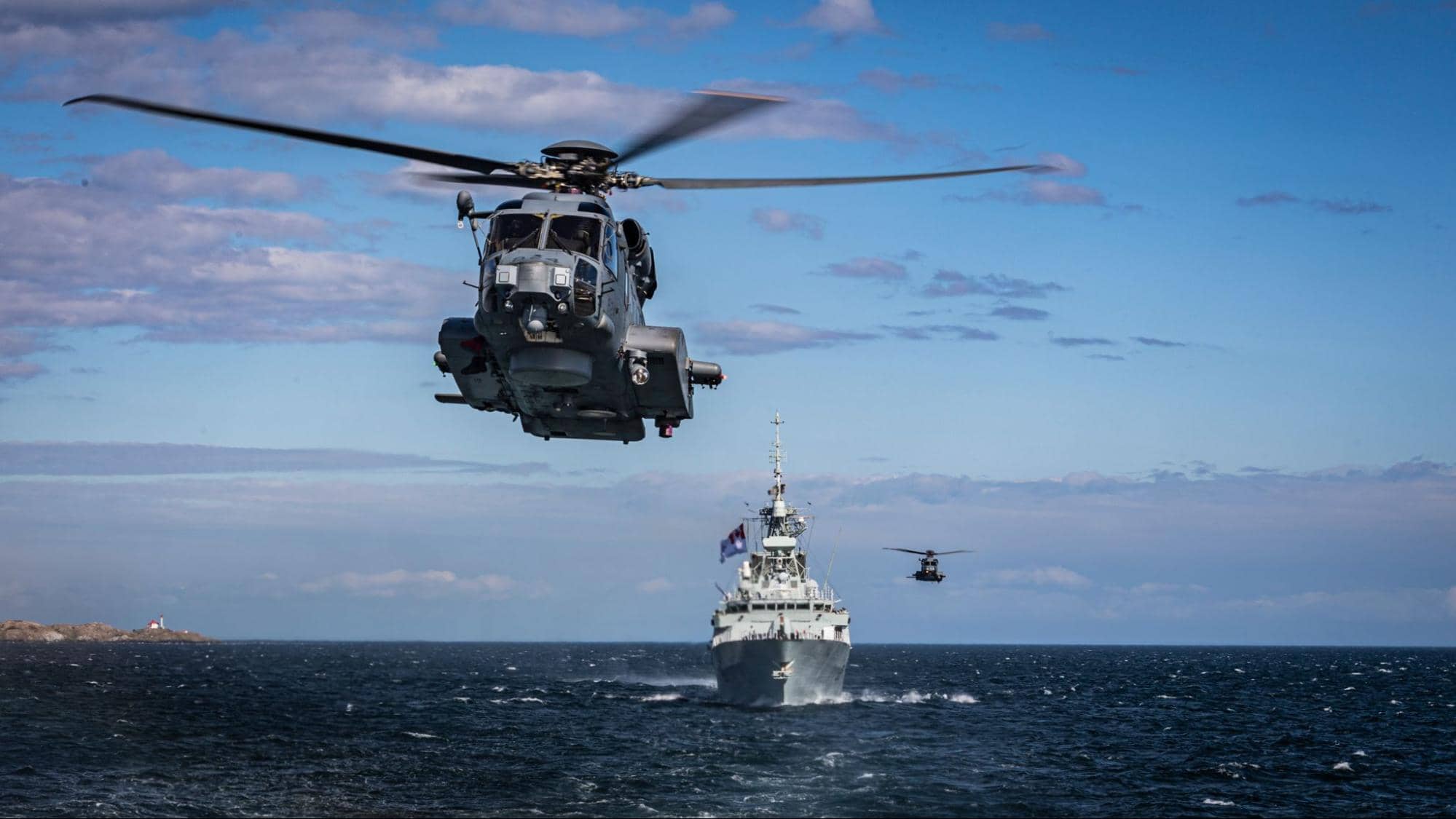 HMCS Winnipeg and HMCS Regina (not pictured) sail past the Greater Victoria Shoreline en route to Hawaii with their embarked Royal Canadian Air Force CH-148 Cyclone helicopters for the Rim of the Pacific exercise (RIMPAC) August 6, 2020. Photo credit: MS Dan Bard, Canadian Forces Combat Camera, Canadian Forces Photo