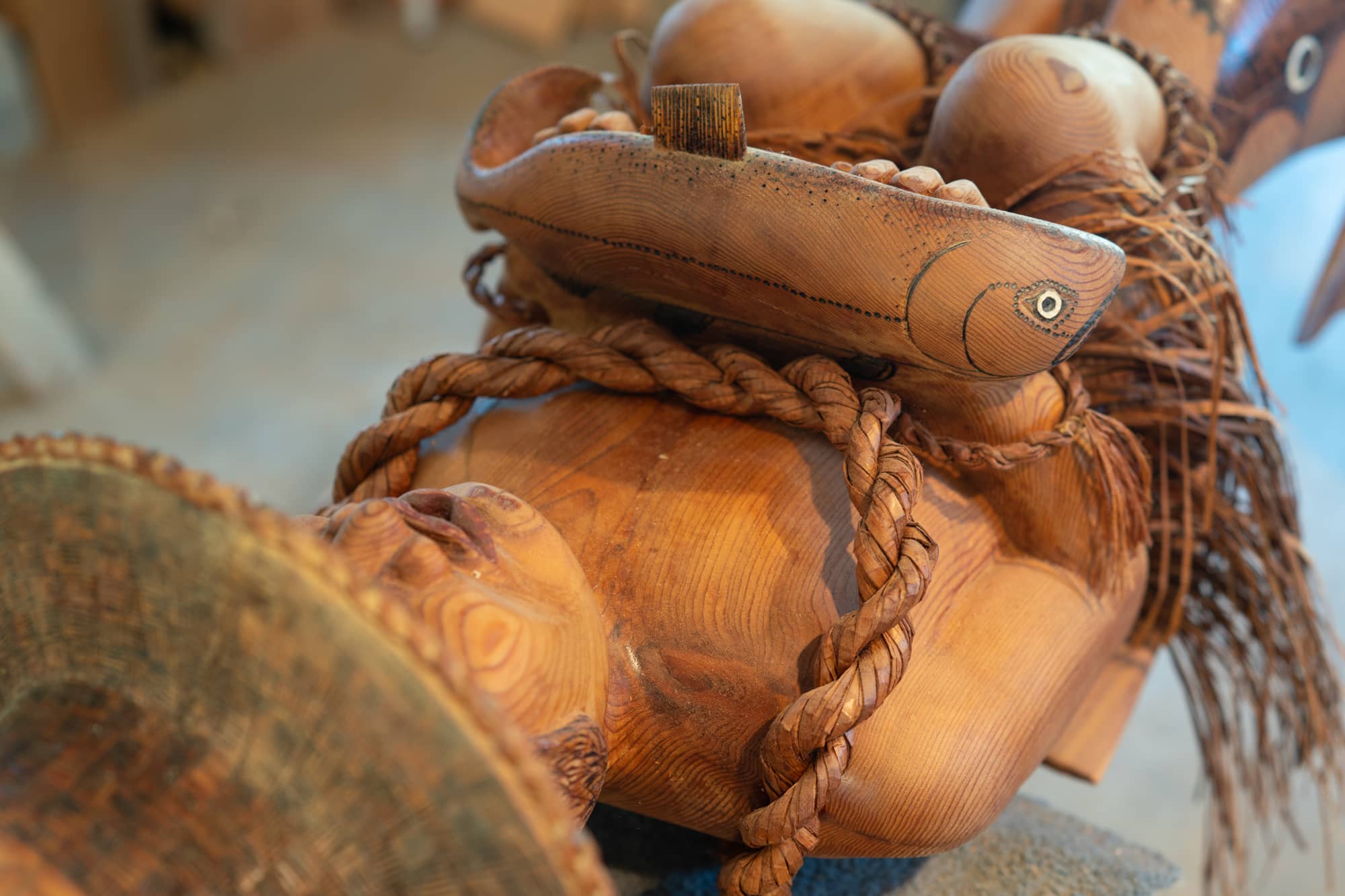 Part of a pole carved by Wuikinuxv Elder George Johnson depicts a person holding a single salmon. Photo: Jimmy Thomson / Capital Daily