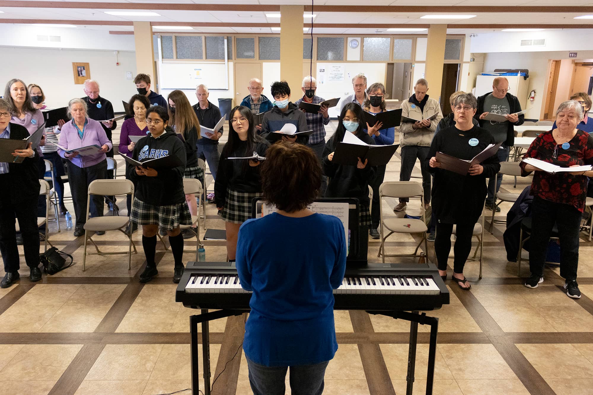 Choral conductor and artistic director Erica Phare-Bergh leads members of the Voices in Motion choir through a recent rehearsal. Photo: Jolene Rudisuela / Capital Daily