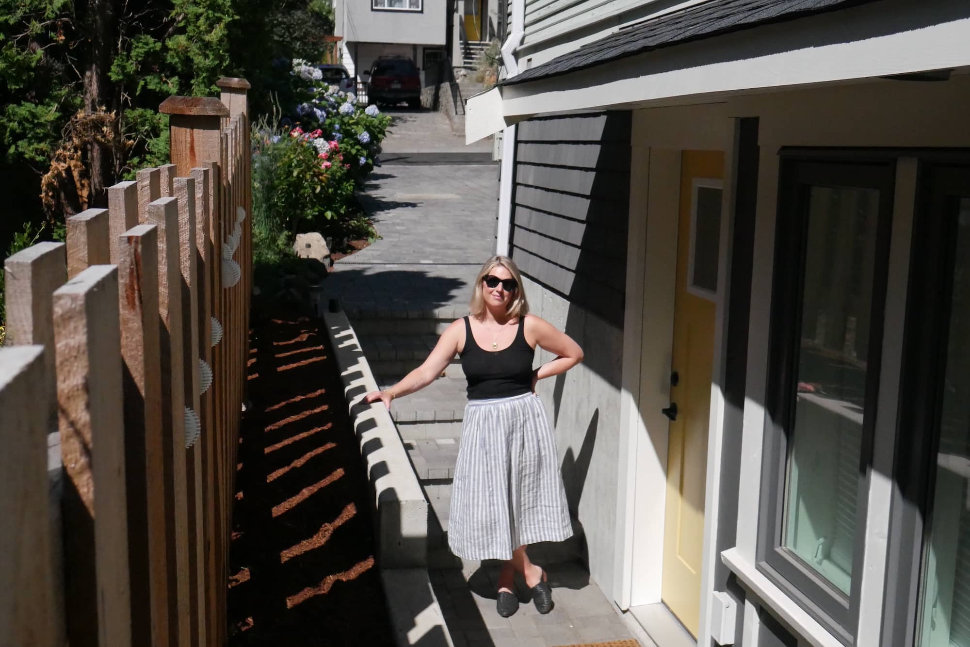 Carla Stucchi outside the entrance to her basement secondary suite. Photo: Evert Lindquist / Capital Daily