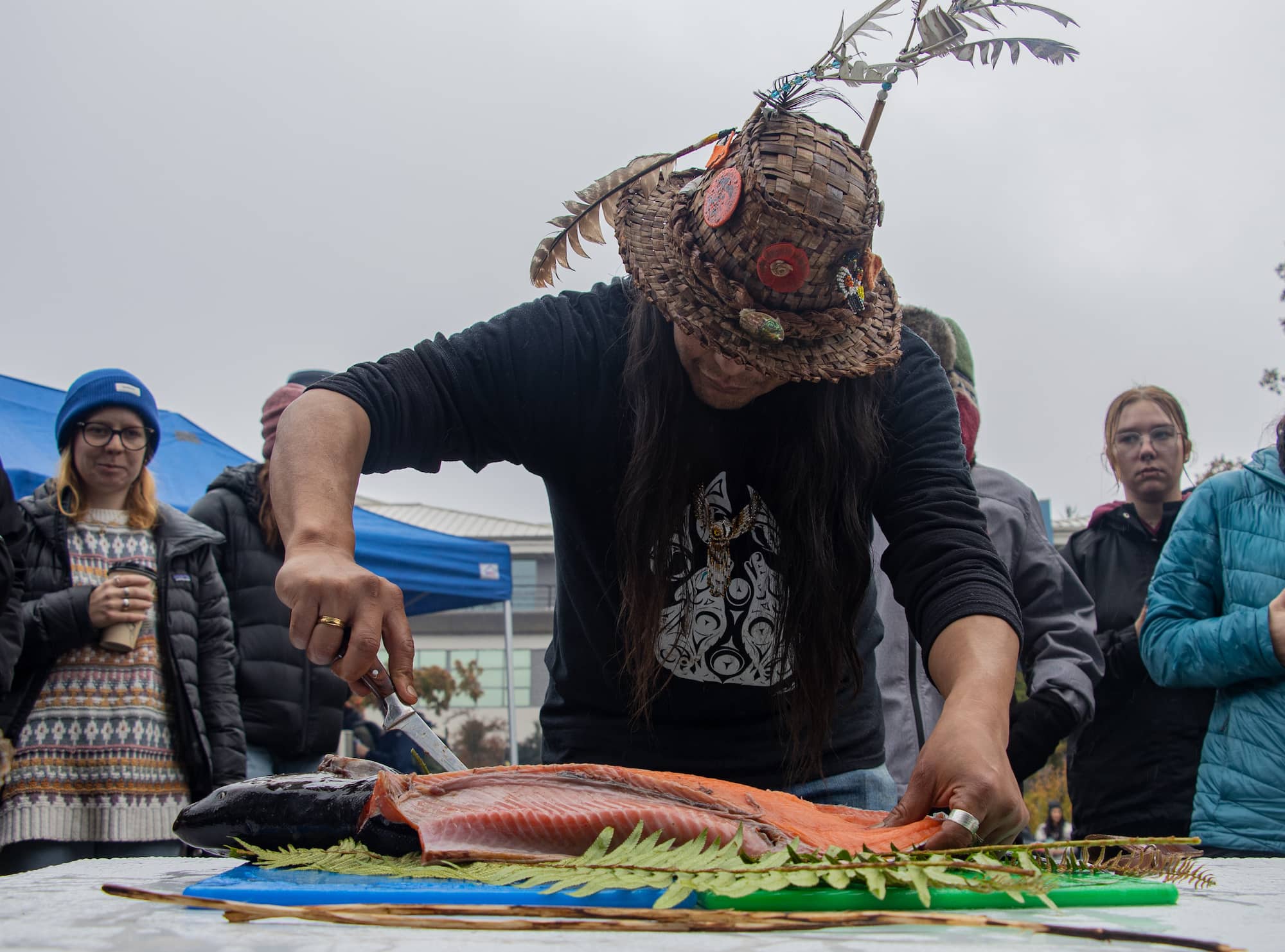 Tsawout knowledge keeper J.B. Williams prepares salmon for the pit cook. All photos by Robyn Bell / Capital Daily