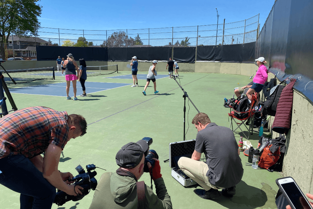 Jordan Mikkers (middle) measures sound at Carnarvon Park pickleball court. Photo: Mark Brennae / Capital Daily