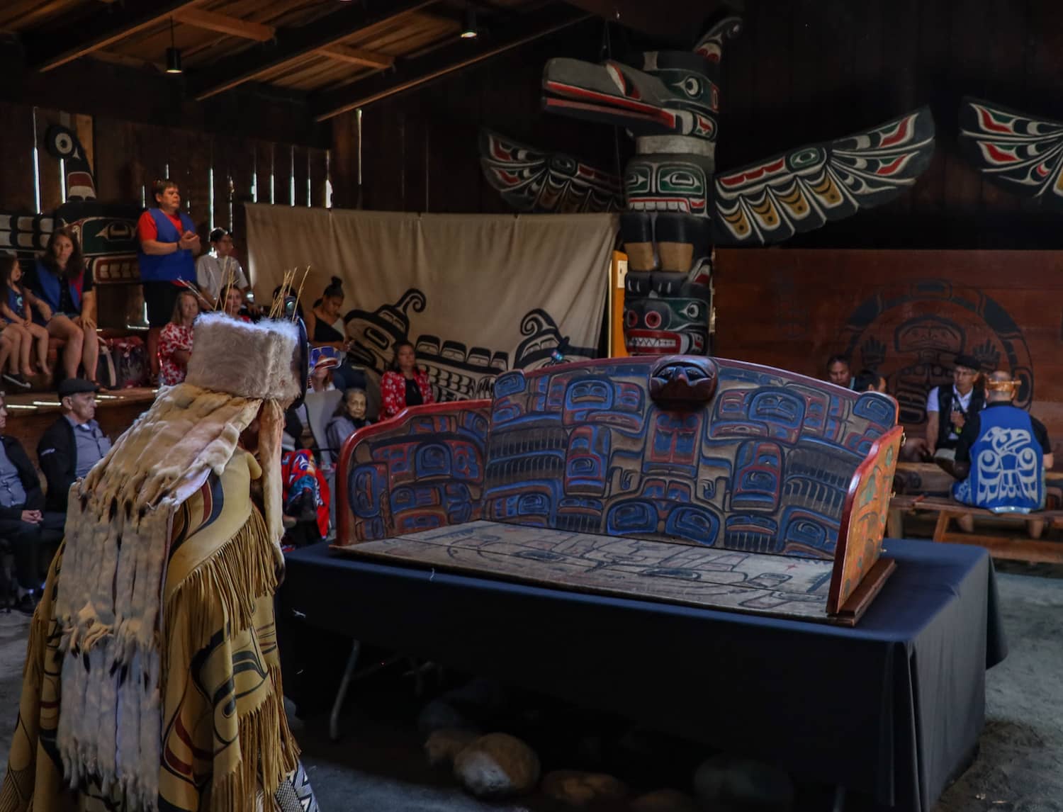 The chief’s seat is blessed by a Heiltsuk member. Photo: Robyn Bell / Capital Daily