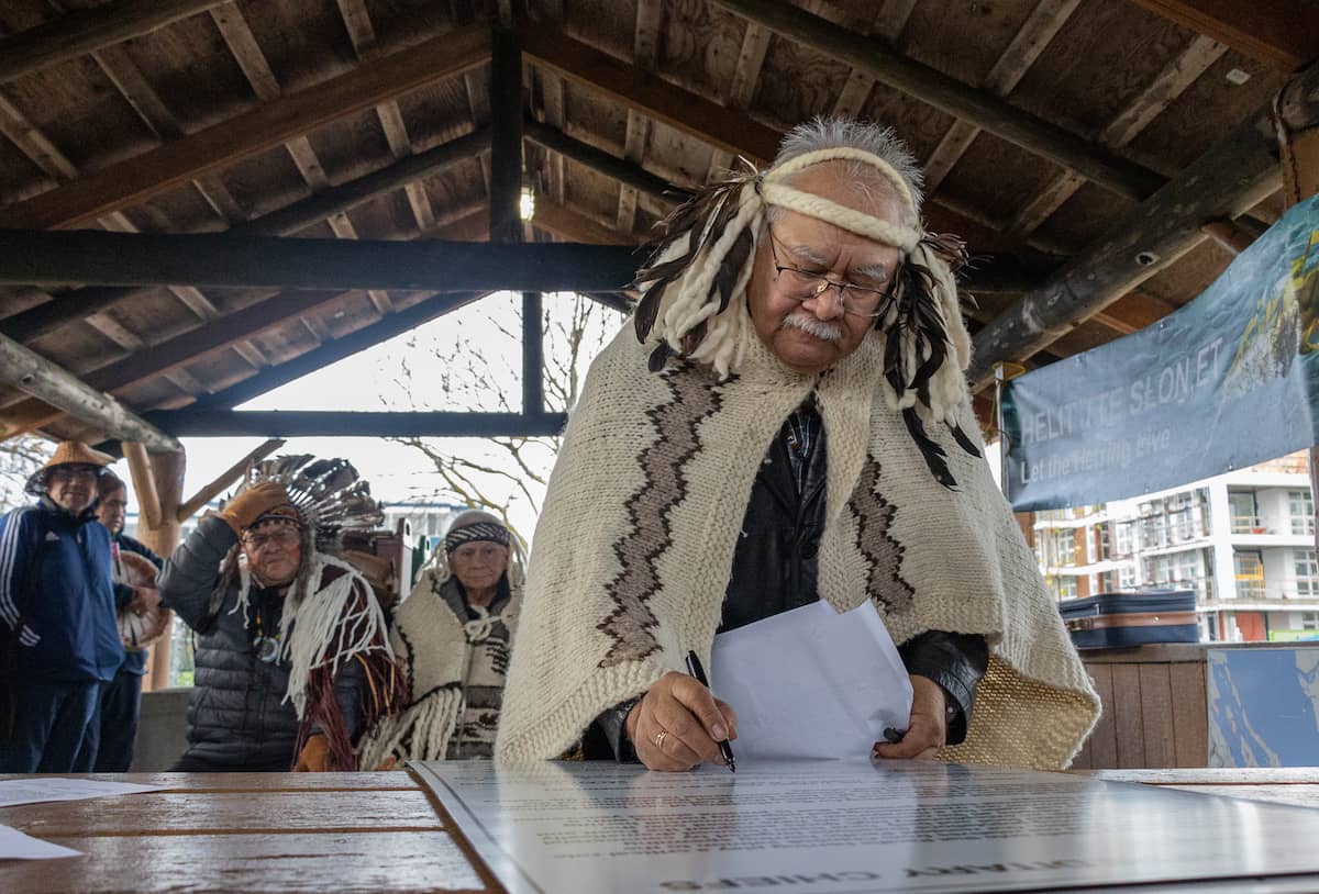 Tsawout Chief WIĆKINEM (Eric Pelkey) signs the declaration in Sidney. Photo: Robyn Bell / Capital Daily