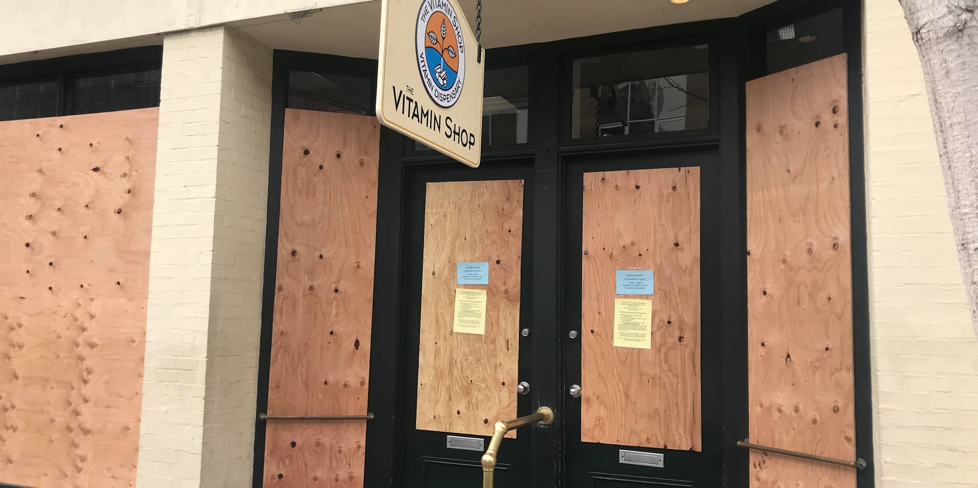 The Vitamin Shop on Broad Street, one of several downtown businesses that have boarded up their windows to protect against a spike in break-ins (Photo by Sean Craig).