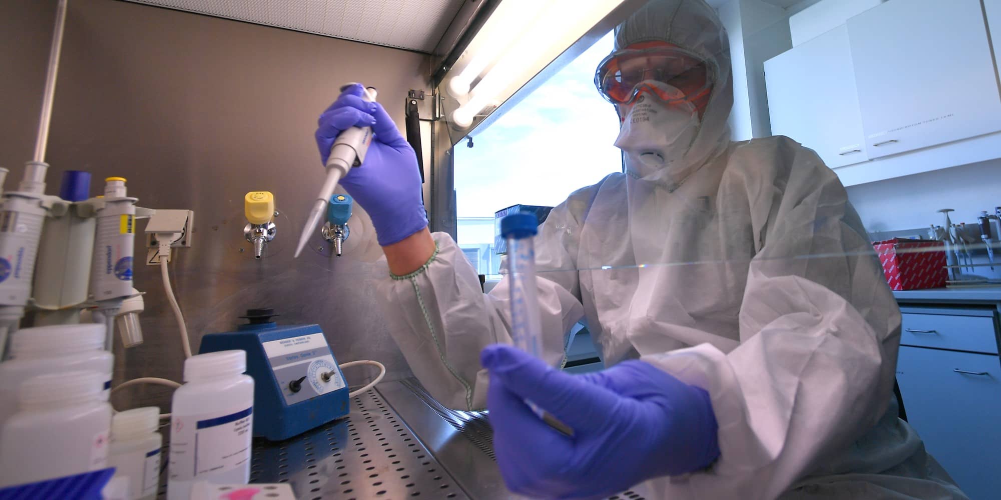 Biologist William G. Dundon with the International Atomic Energy Agency prepares the extraction of the COVID-19 virus genome in this May photo (IAEA).