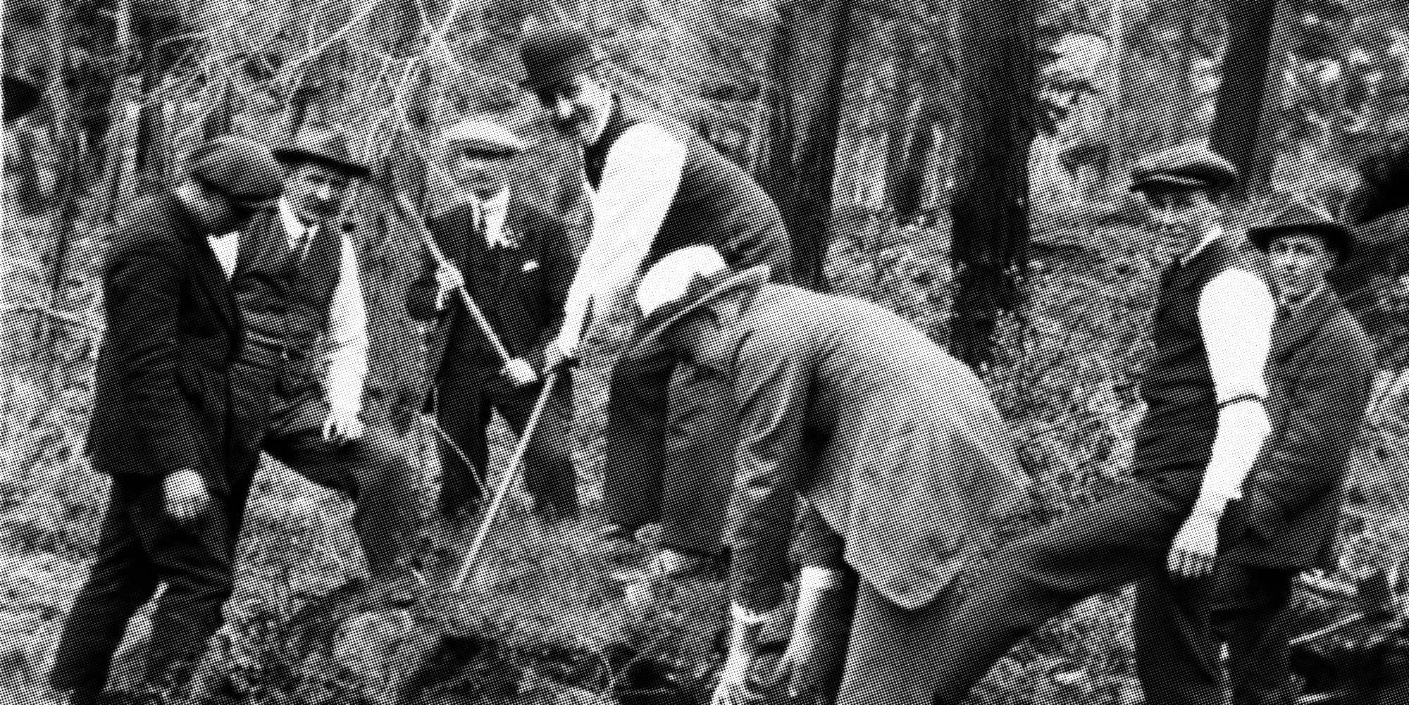 A group of Victorians pictured in 1920 using pickaxes to tear apart a likely centuries-old Lekwungen burial mound near Pedder Bay (Victoria Archives).