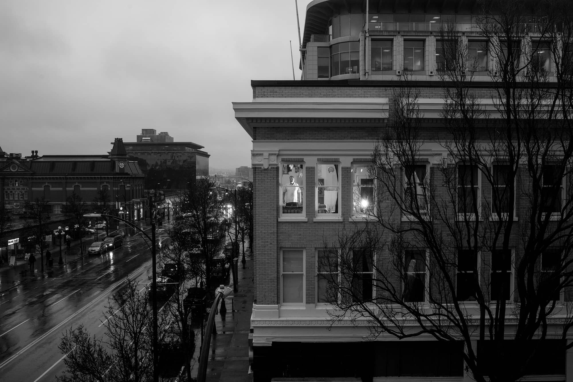 A man stands at the window of the Fairfield Hotel in Victoria. Photo: Rick Collins