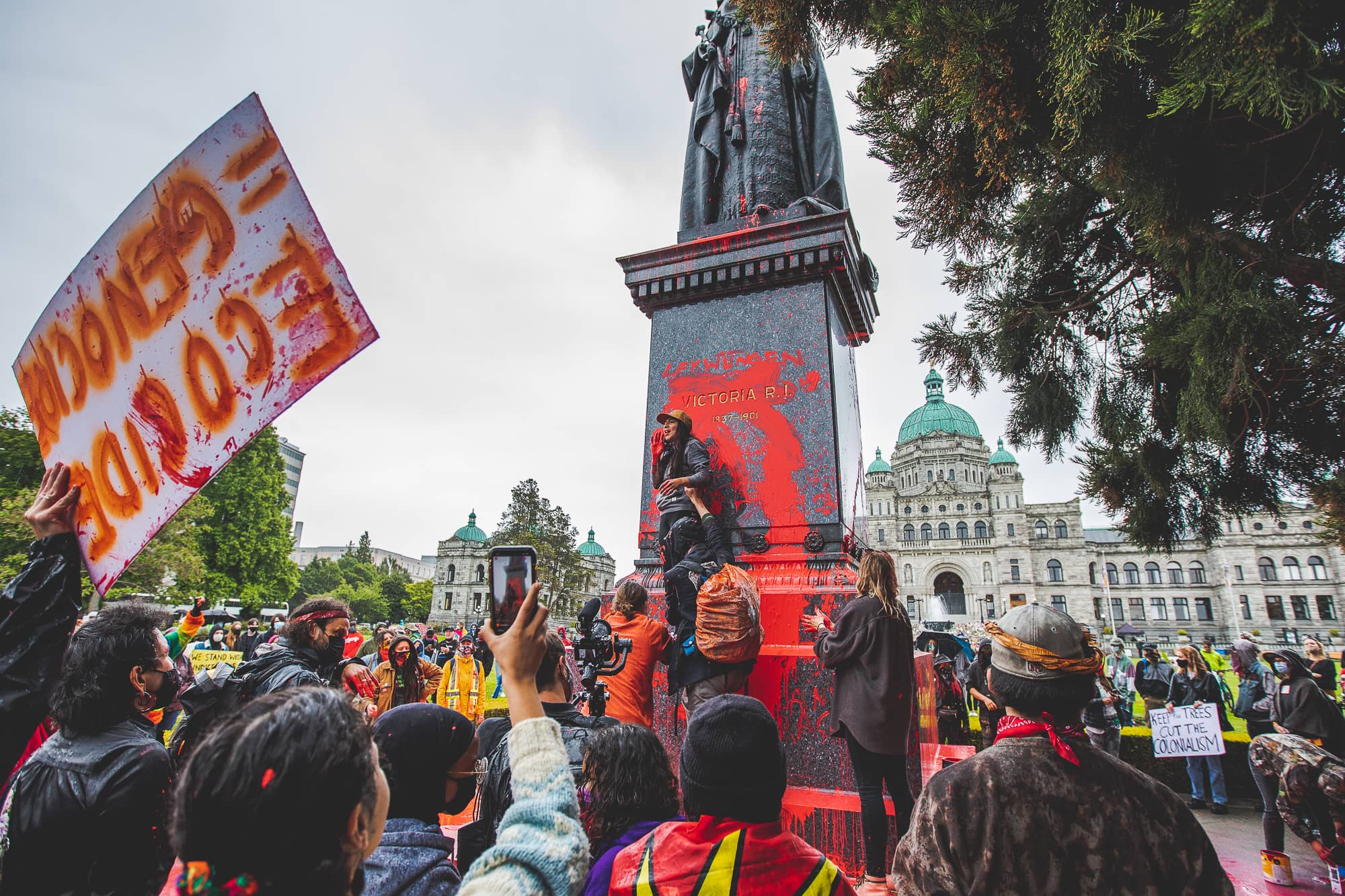 A protest at a statue of Queen Victoria in front of the BC Parliament Buildings. Photo: Colin Smith / Capital Daily
