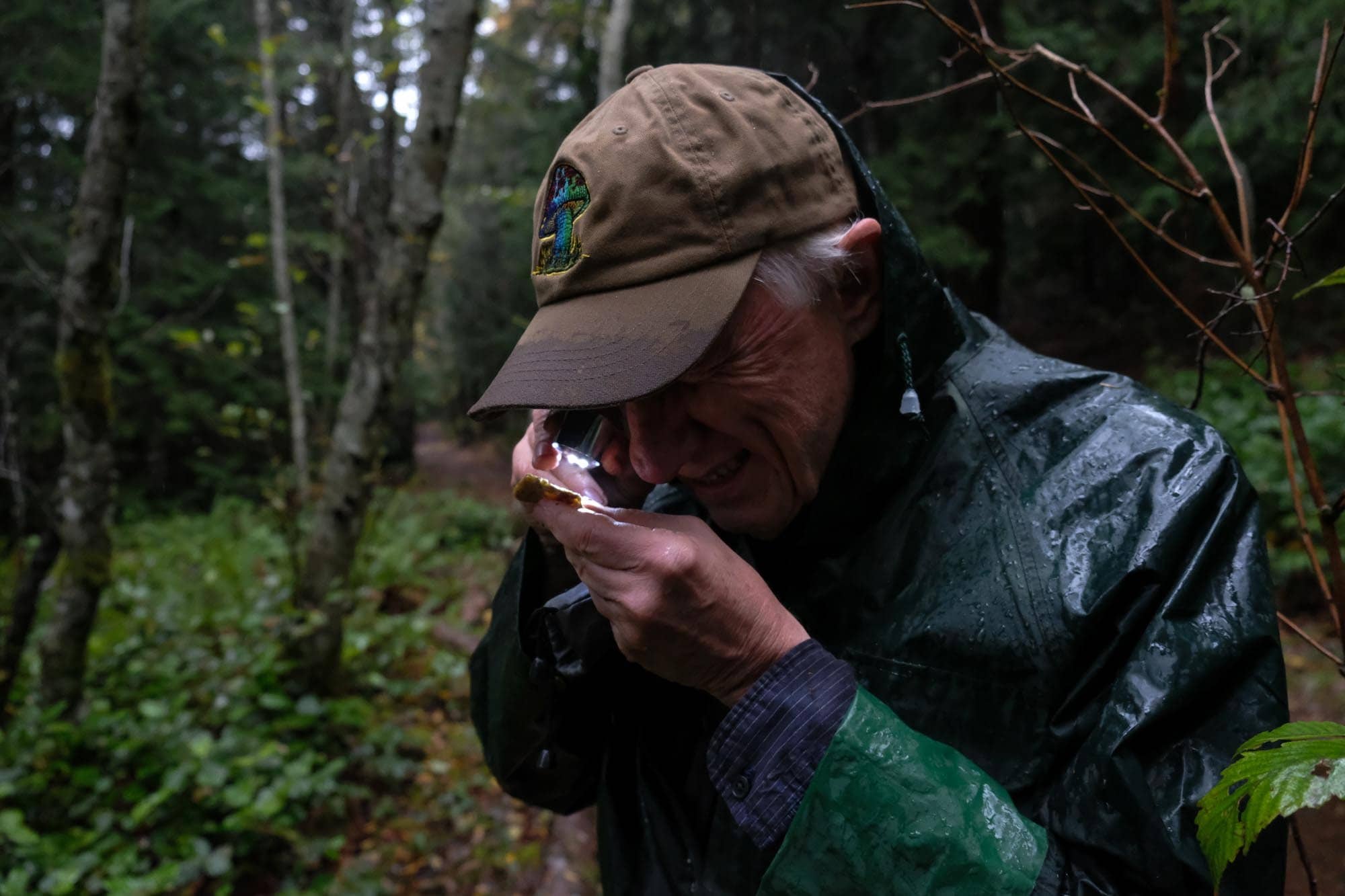 Kem Luther investigating the spores of a turkey tail. Photo: Zoë Ducklow / Capital Daily
