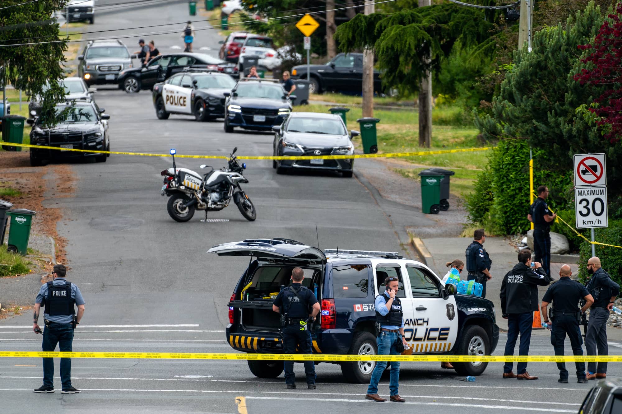 A police officer places a call at the scene of the shooting. Witnesses report cell service was nonexistent near the site of the shooting.
