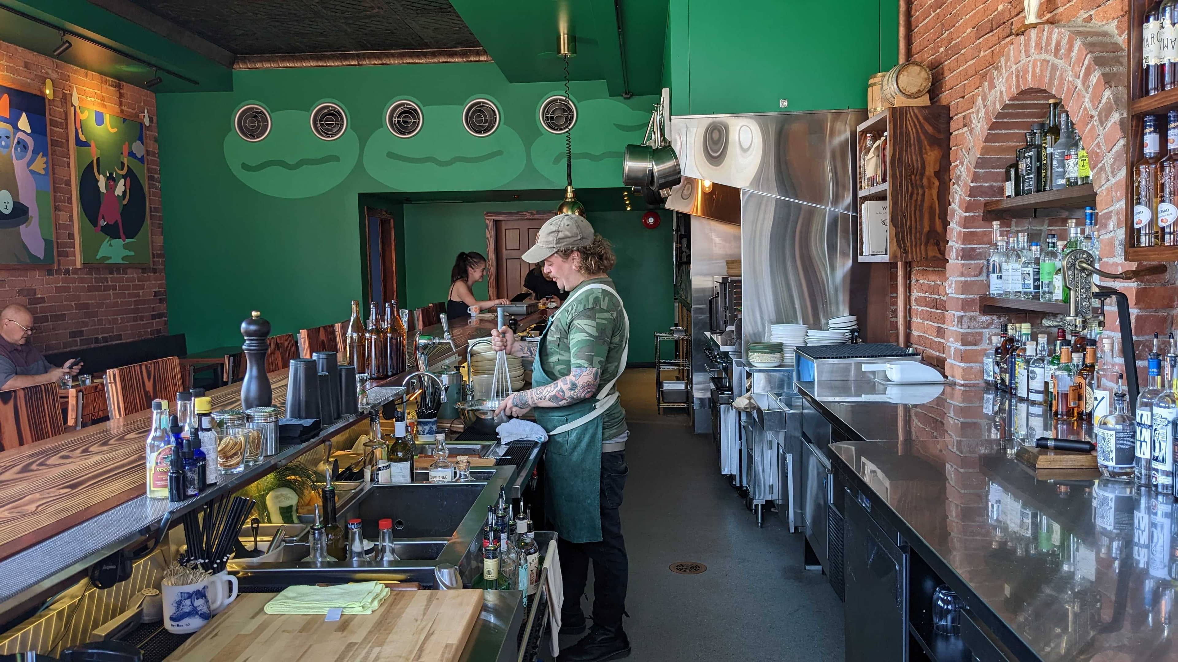 Chef David Fillier mixes a batter for fried oysters with a whisk that's too big for their bowl. Photo: Jimmy Thomson / Capital Daily