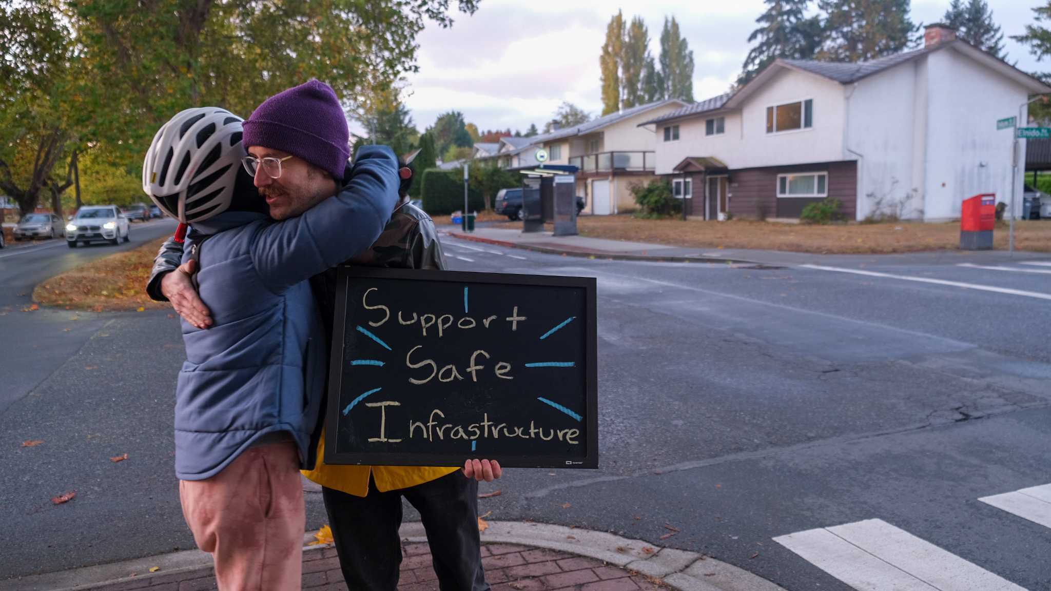 Elise Cote hugs protest attendee Phillip Marciniak. Photo: Michael John Lo / Capital Daily