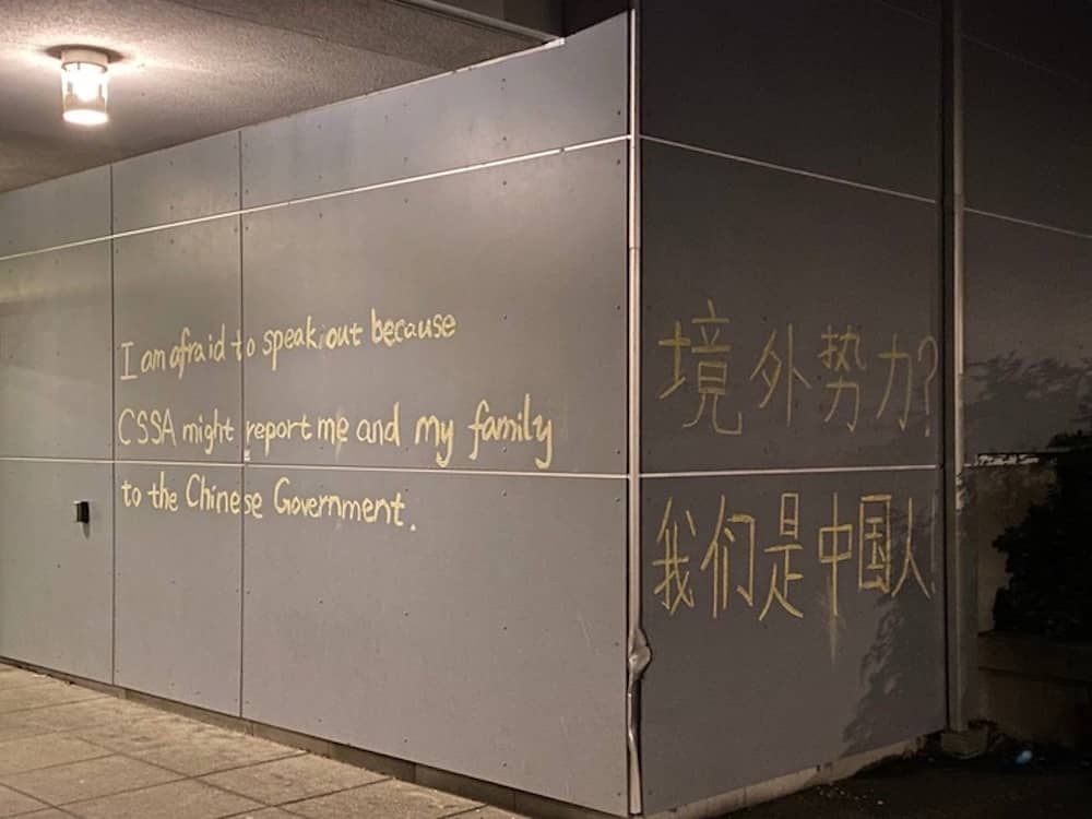 Chalk graffiti on a UVic campus building. On the right, written in Chinese, is a statement mocking the belief that overseas dissenting voices are a result of foreign forces: 'Foreign Interference? We are Chinese!' Photo: Provided