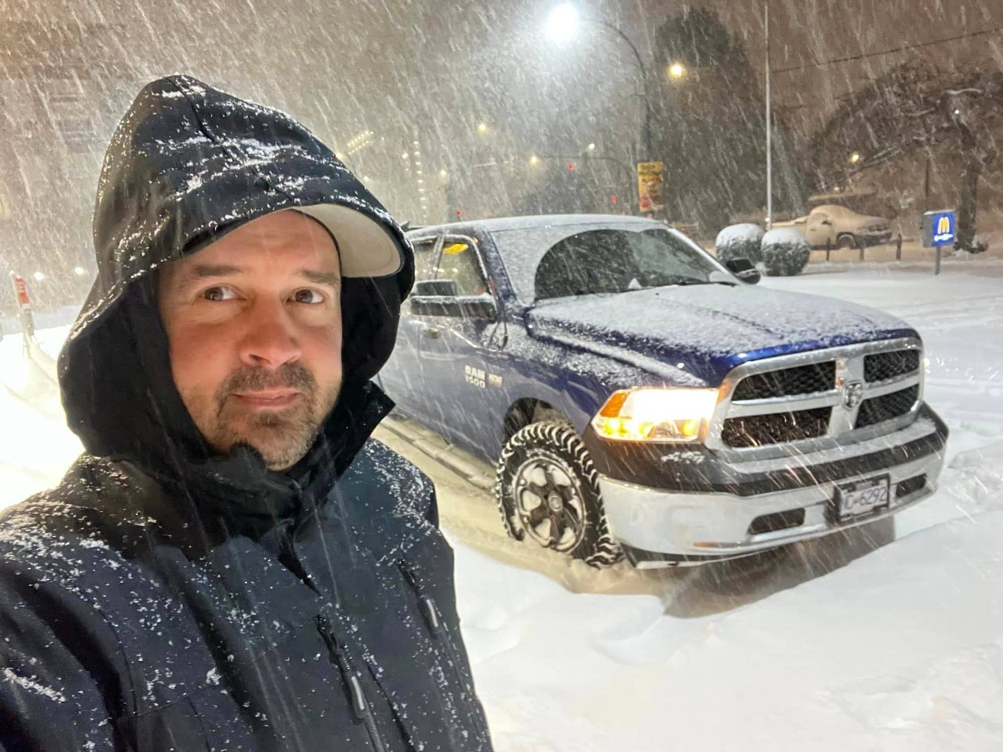 Aaron Watson waits by his truck on a snowy December morning in Victoria. Photo submitted.