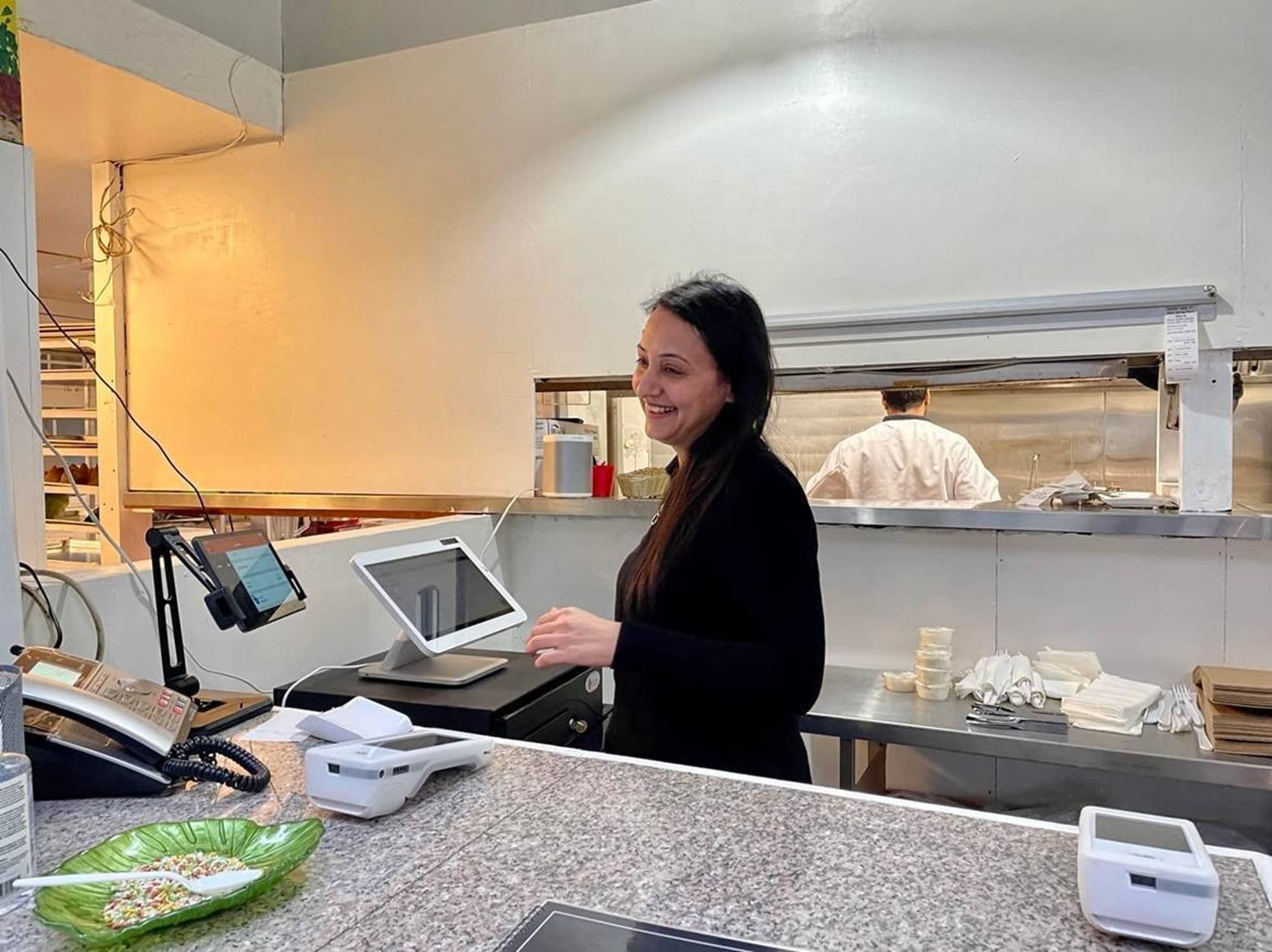 Mona Saqib fields customers at Biryani Palace. Photo: Brishti Basu / Capital Daily