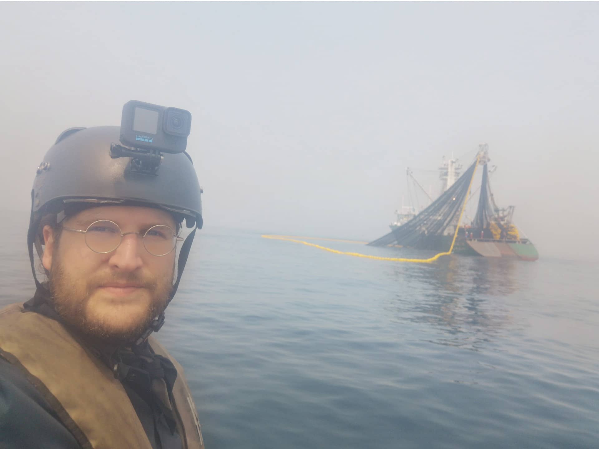 Teale Phelps Bondaroff off the coast of Gabon with a legal fishing vessel in the background in the summer of 2022. Photo: Teale Phelps Bondaroff / Fridtjof Nansen Institute