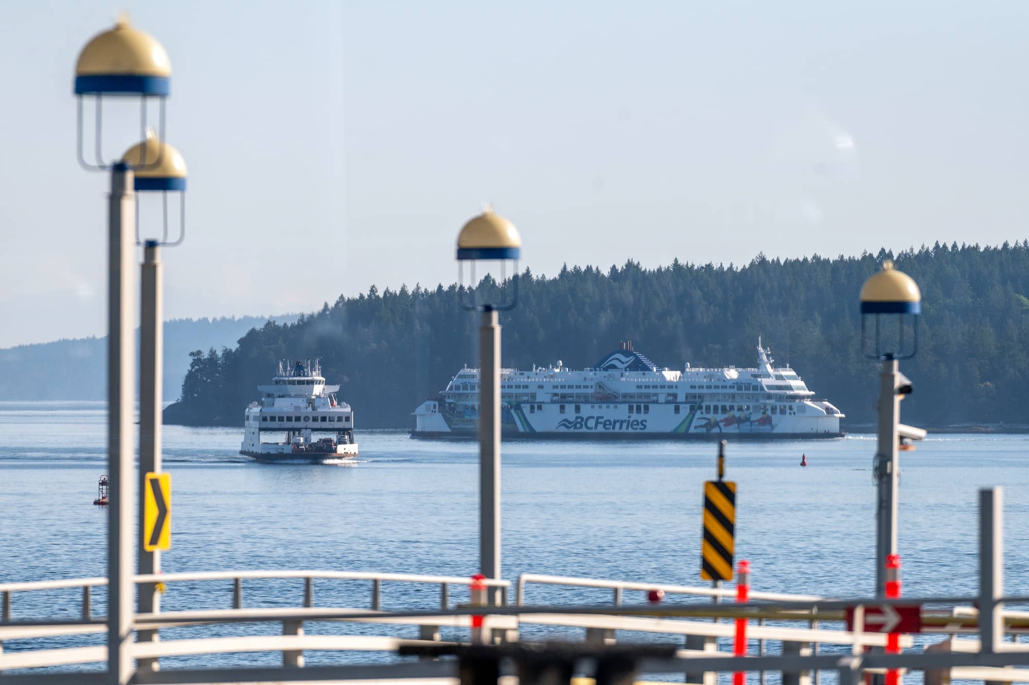 The MV Coastal Renaissance on the right departs the Swartz Bay terminal for Tsawwassen and the mainland, while the MV Queen of Cumberland on the left arrives from Salt Spring Island. Photo: James MacDonald / Capital Daily