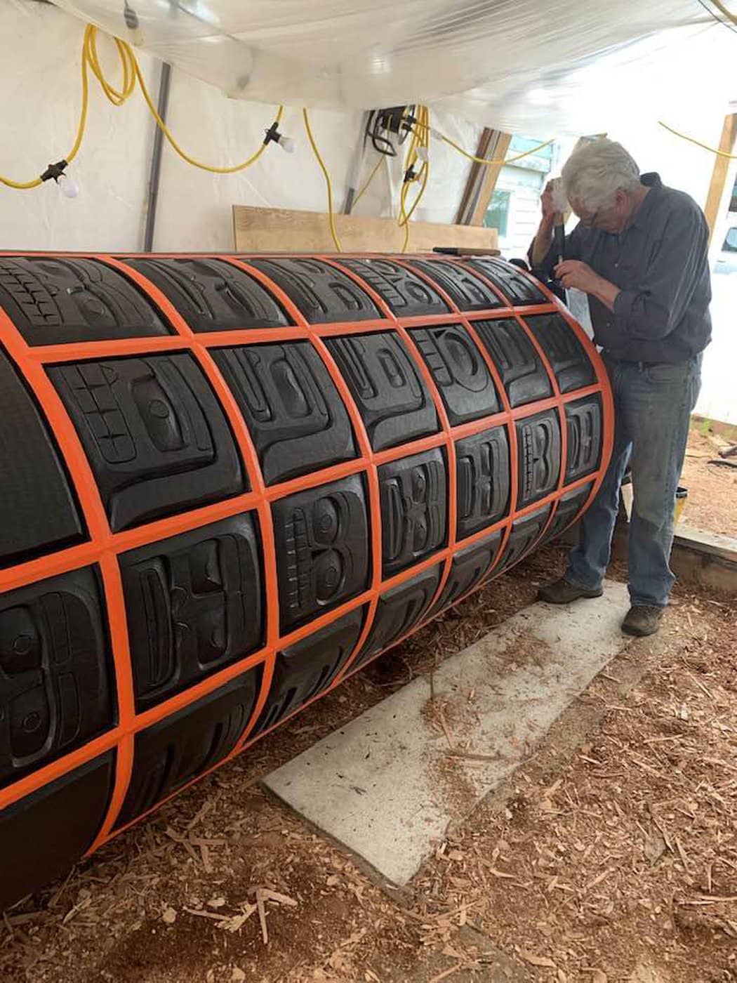 Artist Stanley Hunt works on the residential school memorial pole that will be installed in Vancouver June 21. Photo submitted.