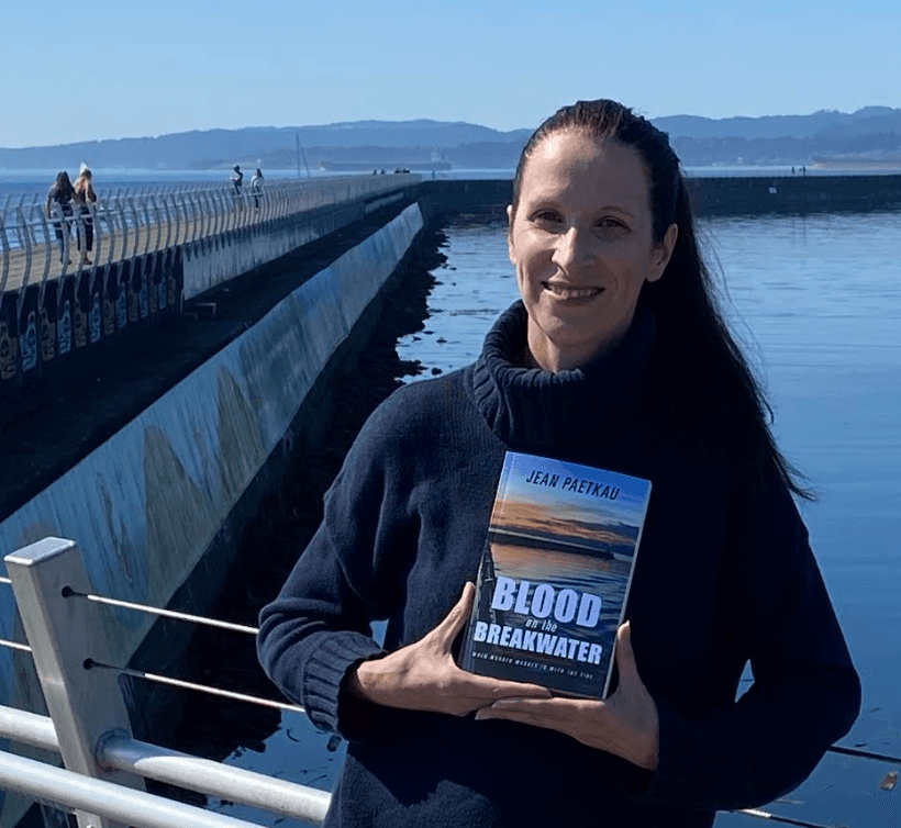 Jean Paetkau poses with her book on Victoria's Breakwater. Photo: Mark Brennae, Capital Daily