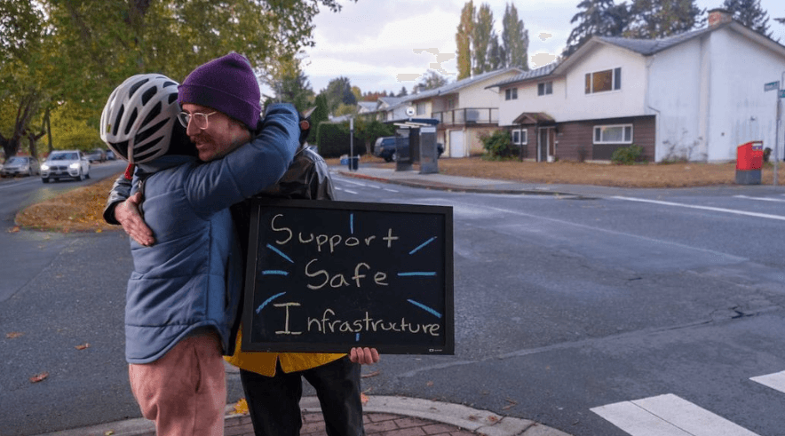 Elise Cote hugs protest attendee Phillip Marciniak. File Photo: Michael John Lo / Capital Daily