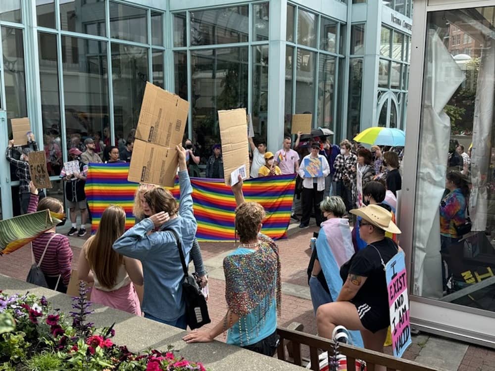 Participants and protesters at the We Unify conference at the VCC. Photo: Sidney Coles / Capital Daily