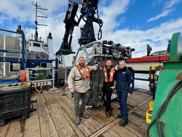 (L-R) Canpac Marine president Ryan Anderson, Josh Tetarenko, Canpac’s director of ROV operations, and Meghan Paulson, ONC executive director of observatory operations, pose with Canada’s newest deep-sea droid rated to work 6K metres deep into the ocean. Ocean Networks Canada Facebook photo