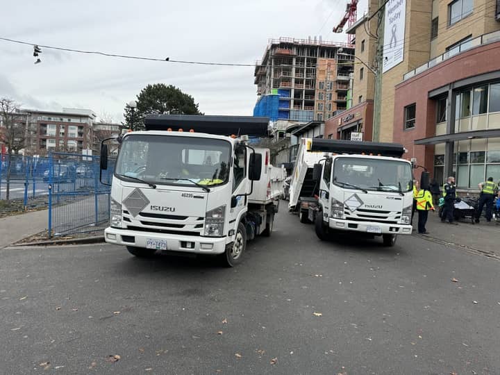 Dump trucks are loaded with belongings identified by Victoria bylaw officers as trash during a recent clearing of Pandora. Photo: Sidney Coles / Capital Daily