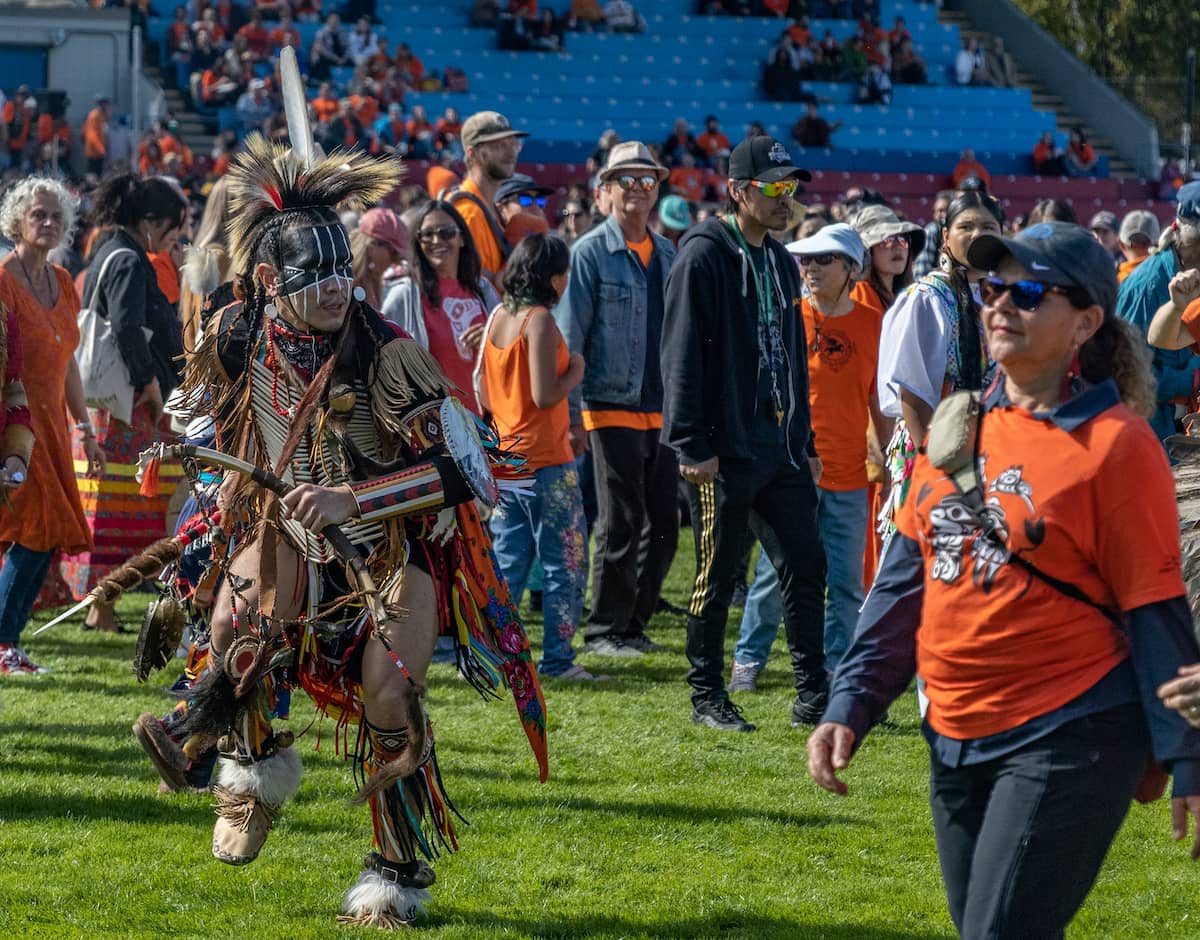 People walk and dance around the powwow circle during the intertribal portion. Photo: Robyn Bell / Capital Daily